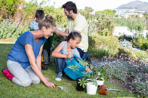 Professional gardening team in Cubitt Town working on a maintained garden